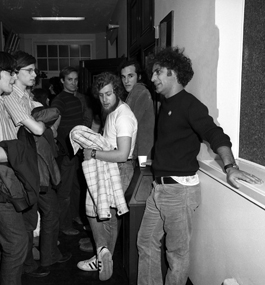 Abbie Hoffman talks with students in a hallway in 1972